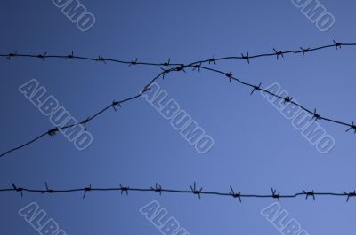 Barbed wire against a blue sky
