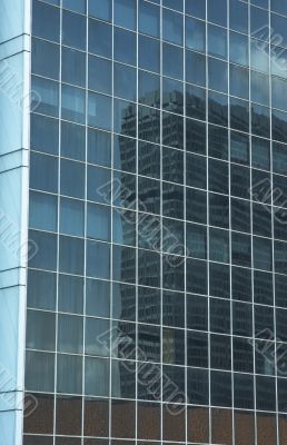 reflection in the windows of office building
