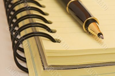 yellow notebook and pen