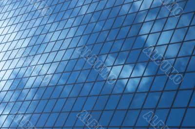 sky reflecting in windows of office building