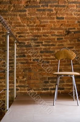 The steel chair befor a brick wall