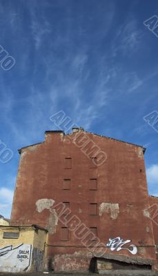 old red house over blue sky