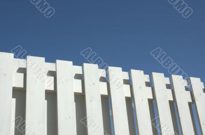 white fence against blue sky