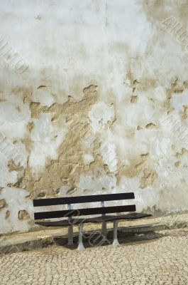 bench and grunge wall