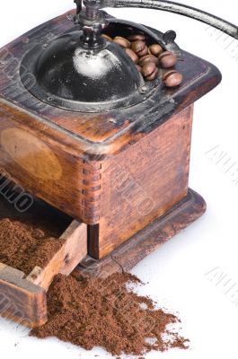 old coffee grinder with beans isolated