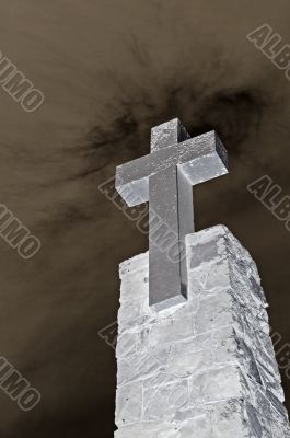 stone cross over blue sky