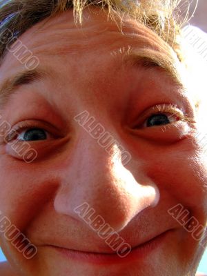 The person of a smiling young man. A funny picture
