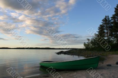 view of the lake with green boat on the coast