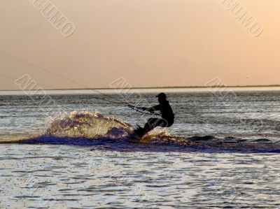 Silhouette of a kitesurf on a gulf on a sunset 2