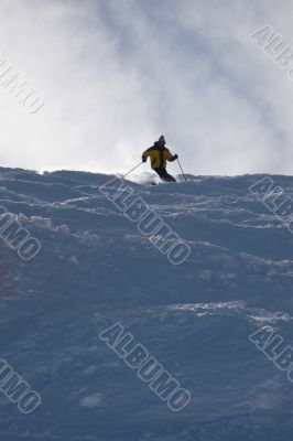 Yellow skier in powder snow