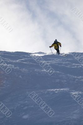 Yellow skier in powder snow