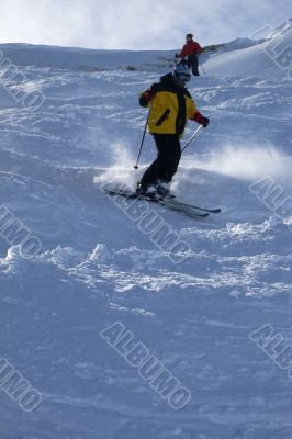 Yellow skier in powder snow