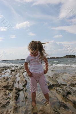 Girl on cloudy coast