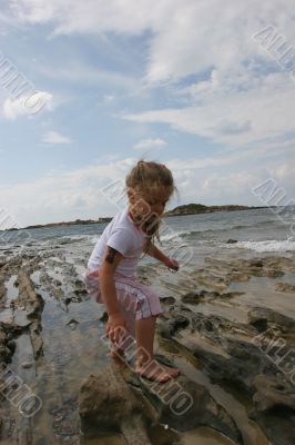 Girl on cloudy coast