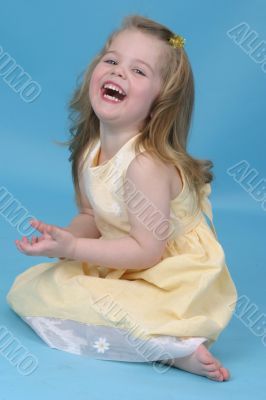 Girl in a blue studio smiling