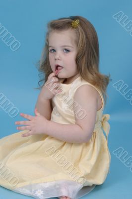 Girl in a blue studio smiling