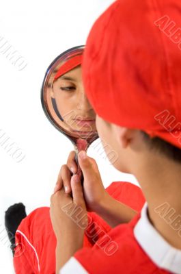 young boy holding a mirror