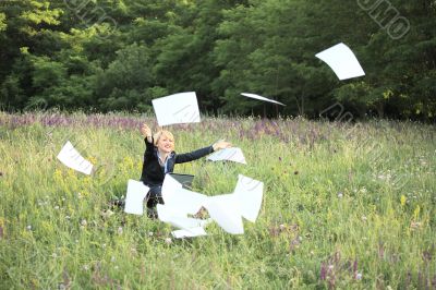 Businesswoman on nature with laptop catch documents #2