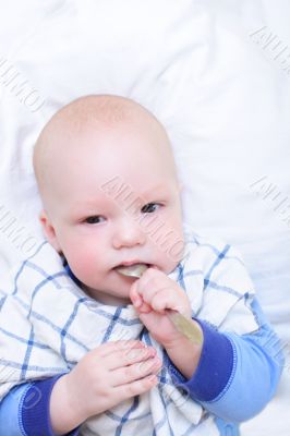 Baby put spoon in mouth