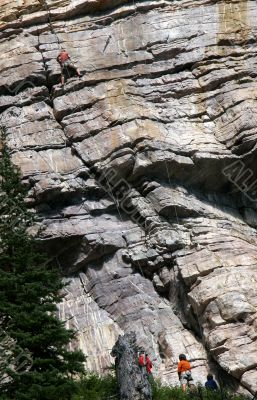 Rock climber with helpers