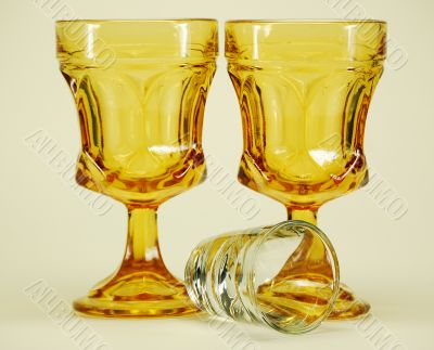 yellow stemmed drinking glasses and shot glass