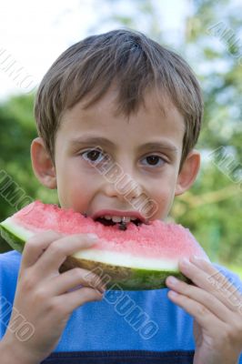 Boy eats watermelon