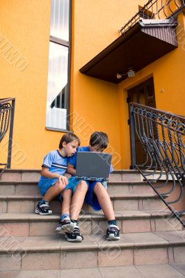 Two cute boy study on computer