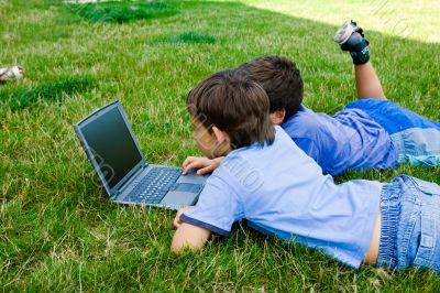 Two cute boy study on computer