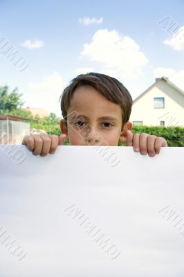 Boy keeps sheet of paper