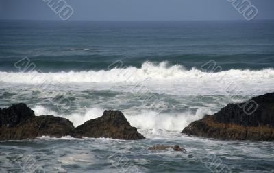 Waves breaking on volcanic rock