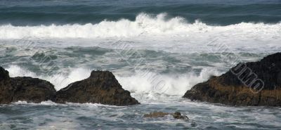 Waves breaking on volcanic rock