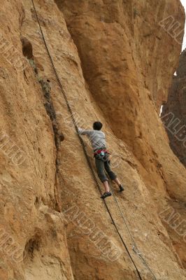 Climber on sheer rock face