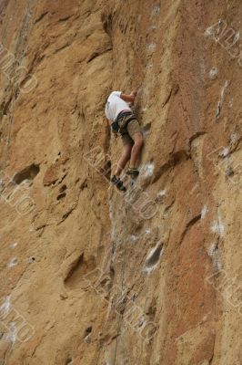 Climber on sheer rock face