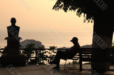 MAN SITTING ON A BENCH
