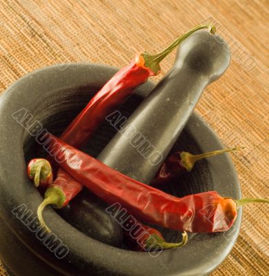 stone mortar with red chillies