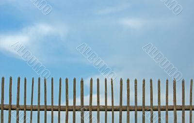 blue sky over old fence
