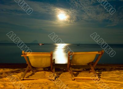 beach chairs at tropical resort - night scene