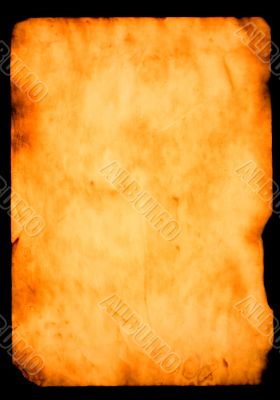 burned paper over black background