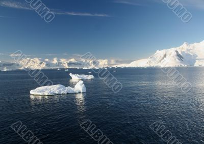 Icebergs, mountains, clear blue sky