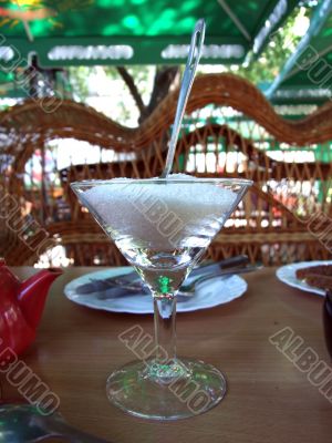 Glass with sugar and the spoon in cafe