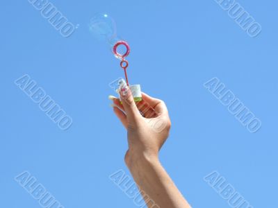 Female hand and soap bubbles