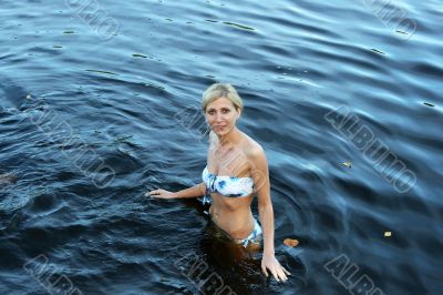 Young woman stand in a lake