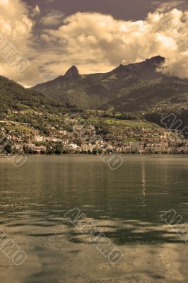 Hotels and mountains on coast of lake.