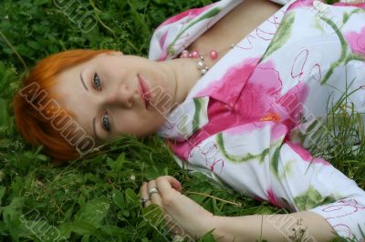 red-haired girl on a grass
