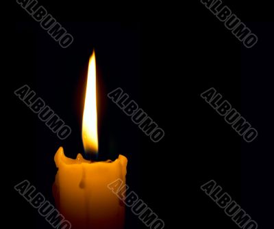 candle flame over black background with copyspace