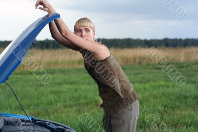 young woman with her broken car