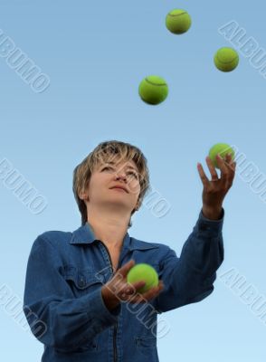 Woman juggling with tennis balls