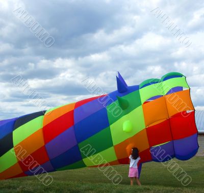 Girl Examines Colorful Wind Sock Kite