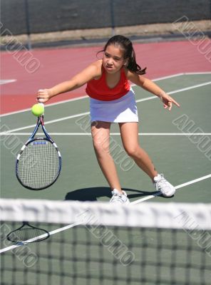 Young girl playing tennis