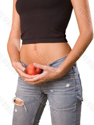 Girl with naked abdomen holding an apple